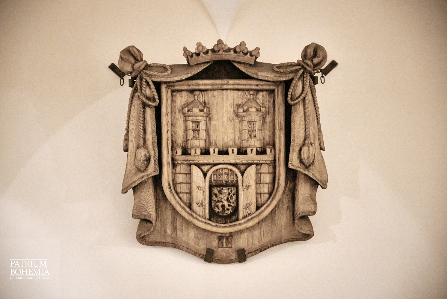 Wooden emblem of the town in the passage of the town hall. Chomutov.